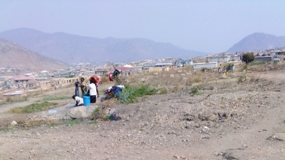 Residents, mostly women in Gimboki queue for water